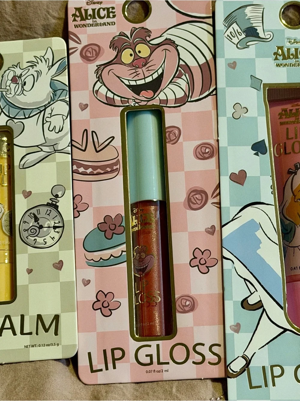 4 piece Alice in Wonderland Lip Gloss & Balm Set - Purple, Gold, Pink, Blue